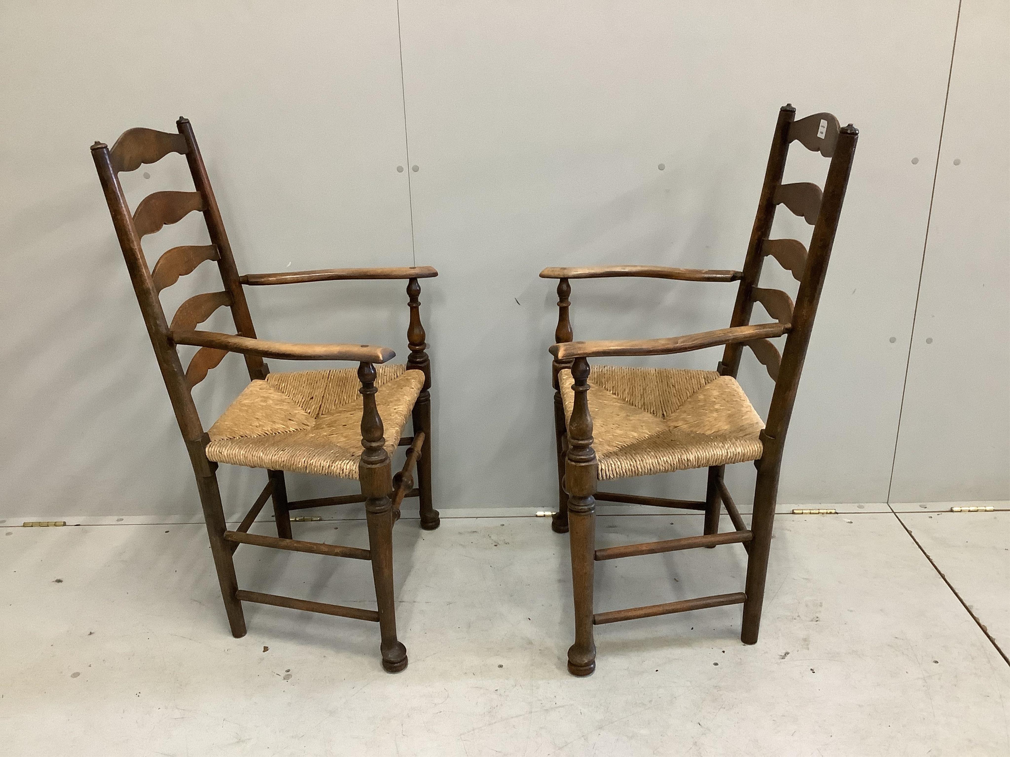 A pair of 19th century beech ladder back elbow chairs, width 54cm, depth 49cm, height 105cm. Condition - poor